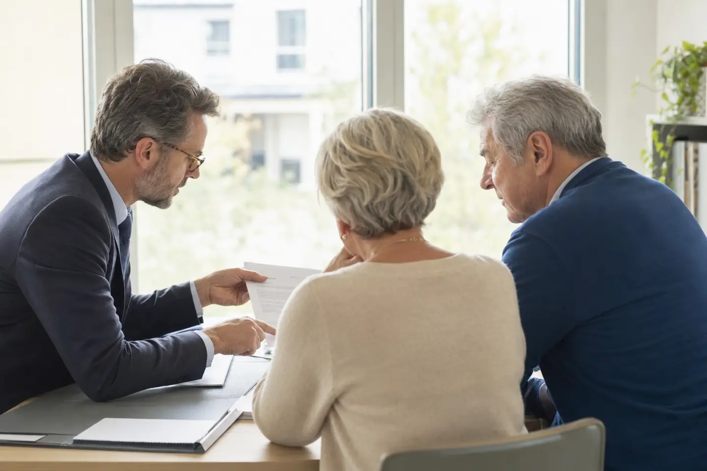 Un conseiller explique le délai de carence d'un contrat obsèques à un couple de seniors
